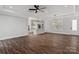 Spacious living room with wood floors, modern light fixtures, and an open view of the kitchen at 1933 Hendricks St, Rock Hill, SC 29732