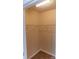 Small walk-in closet with built in racks and tan walls at 2092 Ayrsley Town Blvd, Charlotte, NC 28273