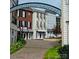 Street-level view of townhouses, showcasing their facades, awnings and sidewalks in a commercial area at 2092 Ayrsley Town Blvd, Charlotte, NC 28273