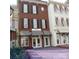 Charming townhouse exterior with brick facade, black shutters, and awnings over storefront entrances at 2092 Ayrsley Town Blvd, Charlotte, NC 28273