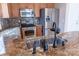 Kitchen with stainless steel appliances, wooden cabinets, granite countertops, and a mosaic backsplash at 2092 Ayrsley Town Blvd, Charlotte, NC 28273