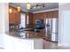 Well-lit kitchen features stainless steel appliances, a stone countertop island, and a mosaic tile backsplash at 2092 Ayrsley Town Blvd, Charlotte, NC 28273