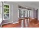 An open-concept living area features hardwood floors, large windows, and bright, neutral paint at 2092 Ayrsley Town Blvd, Charlotte, NC 28273