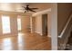 Bright living room features hardwood floors, a ceiling fan, and large windows with natural light at 2092 Ayrsley Town Blvd, Charlotte, NC 28273