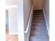 Carpeted stairway with white railing and neutral walls leading to the next floor at 2092 Ayrsley Town Blvd, Charlotte, NC 28273