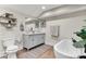 Bright bathroom featuring a soaking tub, modern vanity, and decorative shelving with neutral tones throughout at 2212 Acme Rd, Belmont, NC 28012