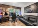 Eclectic music room showcasing guitars, wood paneled wall, and comfortable seating, perfect for a creative space at 2212 Acme Rd, Belmont, NC 28012