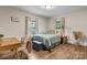 Cozy bedroom featuring a comfortable bed, a stylish desk, and soft natural lighting at 2212 Acme Rd, Belmont, NC 28012