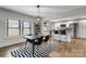 Modern dining area open to the kitchen, featuring a stylish table set and contemporary lighting at 2212 Acme Rd, Belmont, NC 28012