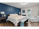 Serene bedroom with a stylish accent wall, comfortable bed, and access to an outdoor patio at 2212 Acme Rd, Belmont, NC 28012