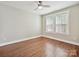 Bright bedroom featuring hardwood floors, modern ceiling fan, and large windows with natural light at 2323 Arden St, Charlotte, NC 28206