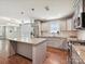 Modern kitchen with a large island and stainless steel appliances overlooking an open living space at 2323 Arden St, Charlotte, NC 28206
