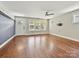 Bright living room with hardwood floors, gray accent wall, and neutral color scheme, offering a cozy and inviting space at 2323 Arden St, Charlotte, NC 28206