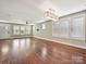 Spacious living room with beautiful hardwood floors and large windows allowing plenty of natural light at 2323 Arden St, Charlotte, NC 28206