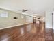 Spacious living room with hardwood floors, a ceiling fan, and access to the open kitchen at 2323 Arden St, Charlotte, NC 28206