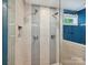 Contemporary shower showcasing sleek tile work, dual shower heads, and a glass enclosure for a luxurious feel at 2323 Arden St, Charlotte, NC 28206