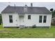 View of the back of this white home, including the door, yard, and roof at 247 E Cabarrus Ave, Concord, NC 28025