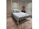 Comfortable bedroom with light blue bedding, a white bed frame, and bright windows at 247 E Cabarrus Ave, Concord, NC 28025