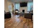 Comfortable living room features wood-look flooring, fireplace, and plenty of seating at 247 E Cabarrus Ave, Concord, NC 28025