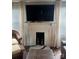Living room features a fireplace, television, and plenty of natural light at 247 E Cabarrus Ave, Concord, NC 28025