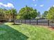 Fenced backyard featuring lush green lawn and mature trees at 2608 Croydon Rd, Charlotte, NC 28209