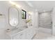 Stylish bathroom featuring double sinks, modern fixtures, and a tiled shower-over-tub with gray brickwork at 2608 Croydon Rd, Charlotte, NC 28209
