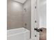 Tiled bath and shower area with modern fixtures and hardware at 2608 Croydon Rd, Charlotte, NC 28209