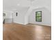 Bright, spacious bonus room featuring hardwood floors, natural light, and a view of the lush outdoors at 2608 Croydon Rd, Charlotte, NC 28209