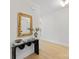 Modern foyer featuring hardwood floors, decorative mirror, and a glass console table at 2608 Croydon Rd, Charlotte, NC 28209