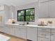 Bright kitchen with white cabinetry, countertops, and modern brass hardware with stainless steel appliances at 2608 Croydon Rd, Charlotte, NC 28209