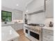 Bright kitchen with white cabinetry, countertops, and stainless steel appliances at 2608 Croydon Rd, Charlotte, NC 28209