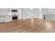 Open-concept living area featuring hardwood floors, modern finishes, and seamless kitchen access at 2608 Croydon Rd, Charlotte, NC 28209