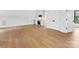 Bright, open-concept living room with hardwood flooring, connecting seamlessly to the kitchen and white cabinets at 2608 Croydon Rd, Charlotte, NC 28209