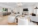 Open-concept living room with hardwood floors, modern decor, and a view of the kitchen at 2608 Croydon Rd, Charlotte, NC 28209