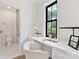 Bright office space with built-in desk, a view to the lush outdoors and easy access to the ensuite bathroom at 2608 Croydon Rd, Charlotte, NC 28209