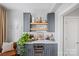 Stylish bar area featuring gray cabinets, open shelving, and a built-in wine cooler at 2863 Grand Union Way, Charlotte, NC 28209