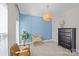 Bedroom featuring a blue accent wall, a modern pendant light, and neutral furnishings at 2863 Grand Union Way, Charlotte, NC 28209