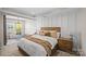 Cozy bedroom featuring a wooden bed frame, decorative pillows, and a sitting area at 2863 Grand Union Way, Charlotte, NC 28209