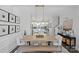 Elegant dining room with hardwood floors, modern lighting, and a view into the bright, contemporary kitchen at 2863 Grand Union Way, Charlotte, NC 28209