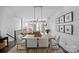 Open dining area with modern lighting and hardwood floors showcasing an open concept view to the living room at 2863 Grand Union Way, Charlotte, NC 28209