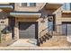 Townhome exterior features a one-car garage, brick facade, a gray front door with a wreath, and metal handrails at 2863 Grand Union Way, Charlotte, NC 28209