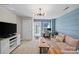 Inviting living room showcasing a blue accent wall, door to deck, comfortable seating, and contemporary decor at 2863 Grand Union Way, Charlotte, NC 28209