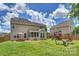 Large backyard featuring lush lawn, playset, patio with seating, and fenced perimeter at 3029 Allendale Dr, Fort Mill, SC 29707