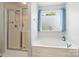 Bright bathroom with a shower, and a soaking tub with a large window at 3029 Allendale Dr, Fort Mill, SC 29707