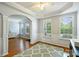 Elegant dining room with tray ceiling, hardwood floors, large windows, and decorative wainscoting at 3029 Allendale Dr, Fort Mill, SC 29707