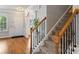Elegant foyer with hardwood floors, staircase with wrought iron spindles, and a view of the front door at 3029 Allendale Dr, Fort Mill, SC 29707