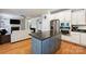 Well-appointed kitchen with stainless appliances, island and granite counters opens to a spacious living room at 3029 Allendale Dr, Fort Mill, SC 29707
