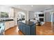 Open kitchen with island and granite counters flows to a comfortable living room with fireplace and TV at 3029 Allendale Dr, Fort Mill, SC 29707