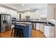 Modern kitchen featuring stainless steel appliances, granite countertops, and a stylish blue island with seating at 3029 Allendale Dr, Fort Mill, SC 29707