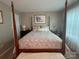 Spacious bedroom with a wooden frame bed and a bright window at 303 Heritage Pkwy, Fort Mill, SC 29715